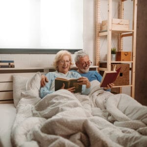 Couple in bed while talking about life insurance