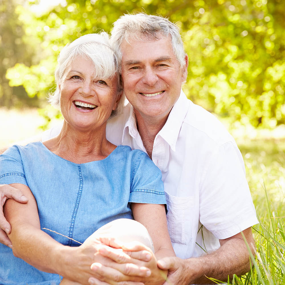 Couple posing because they are happy about their life insurance policy