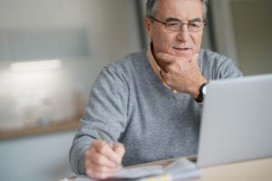 Senior,Man,At,Home,Connected,On,Laptop,Computer